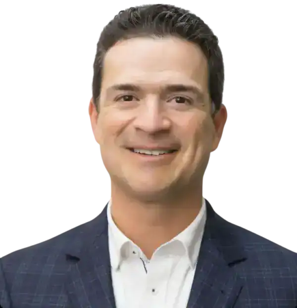 Professional man in a suit smiling, working on blueprint plans.