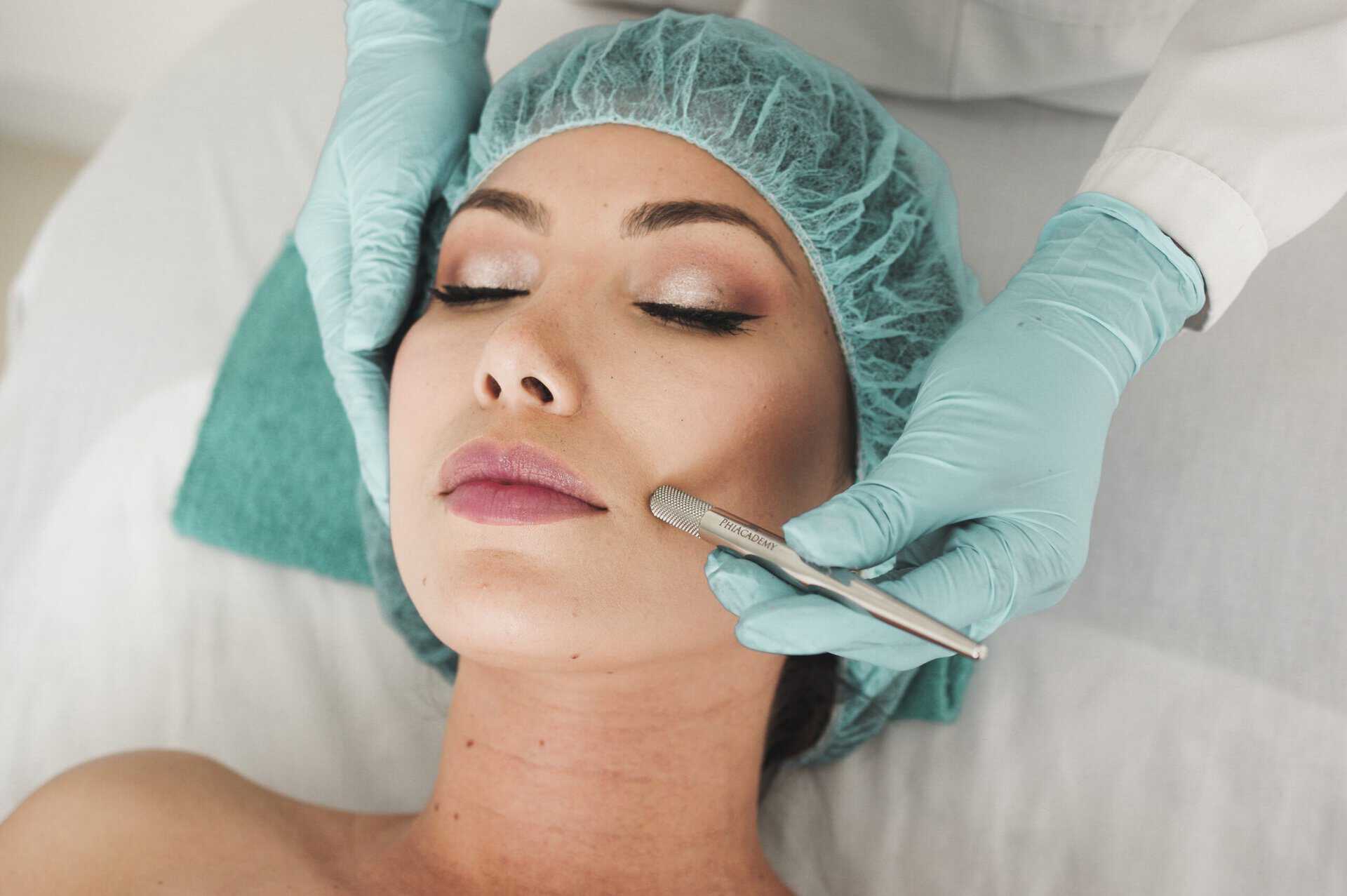 Woman receiving a facial treatment in a medical aesthetics clinic.